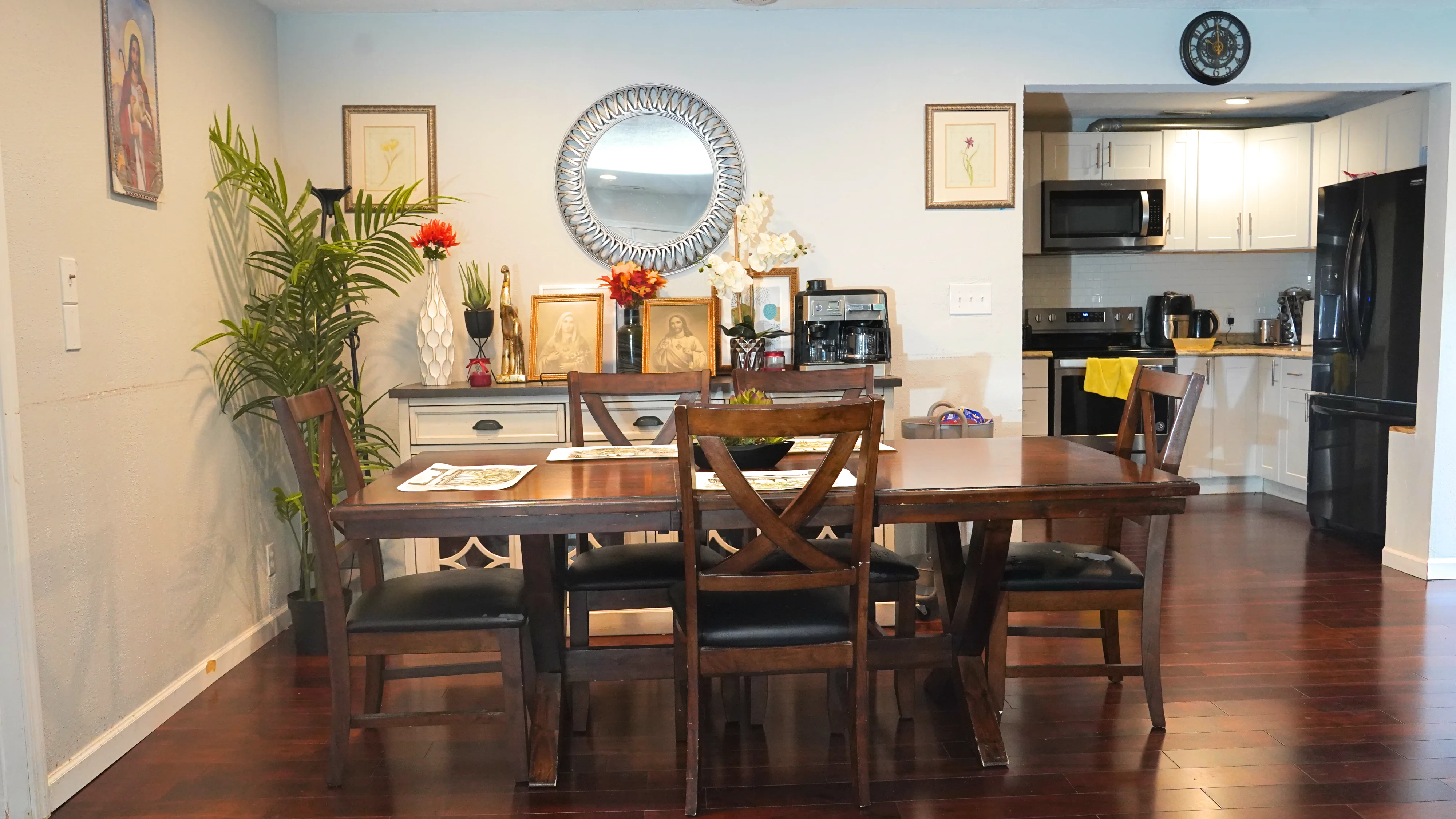 Dining table set with placemats and decorative sideboard