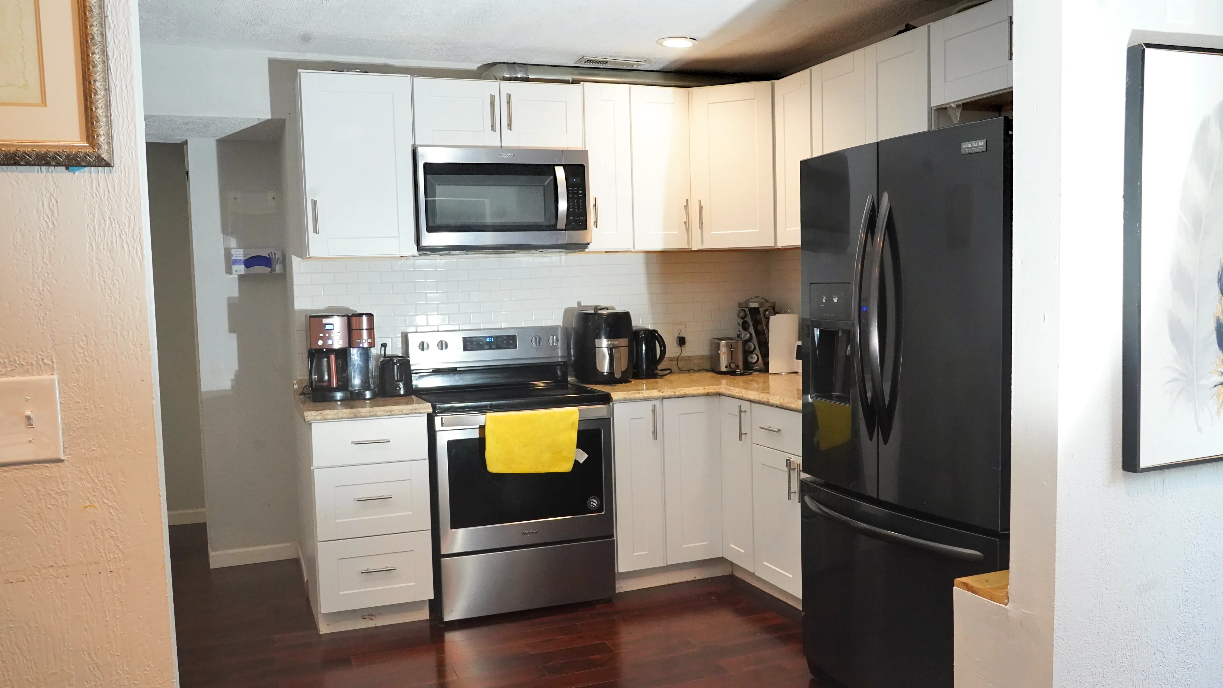 Kitchen with white shaker cabinets, stainless steel appliances, and granite countertops
