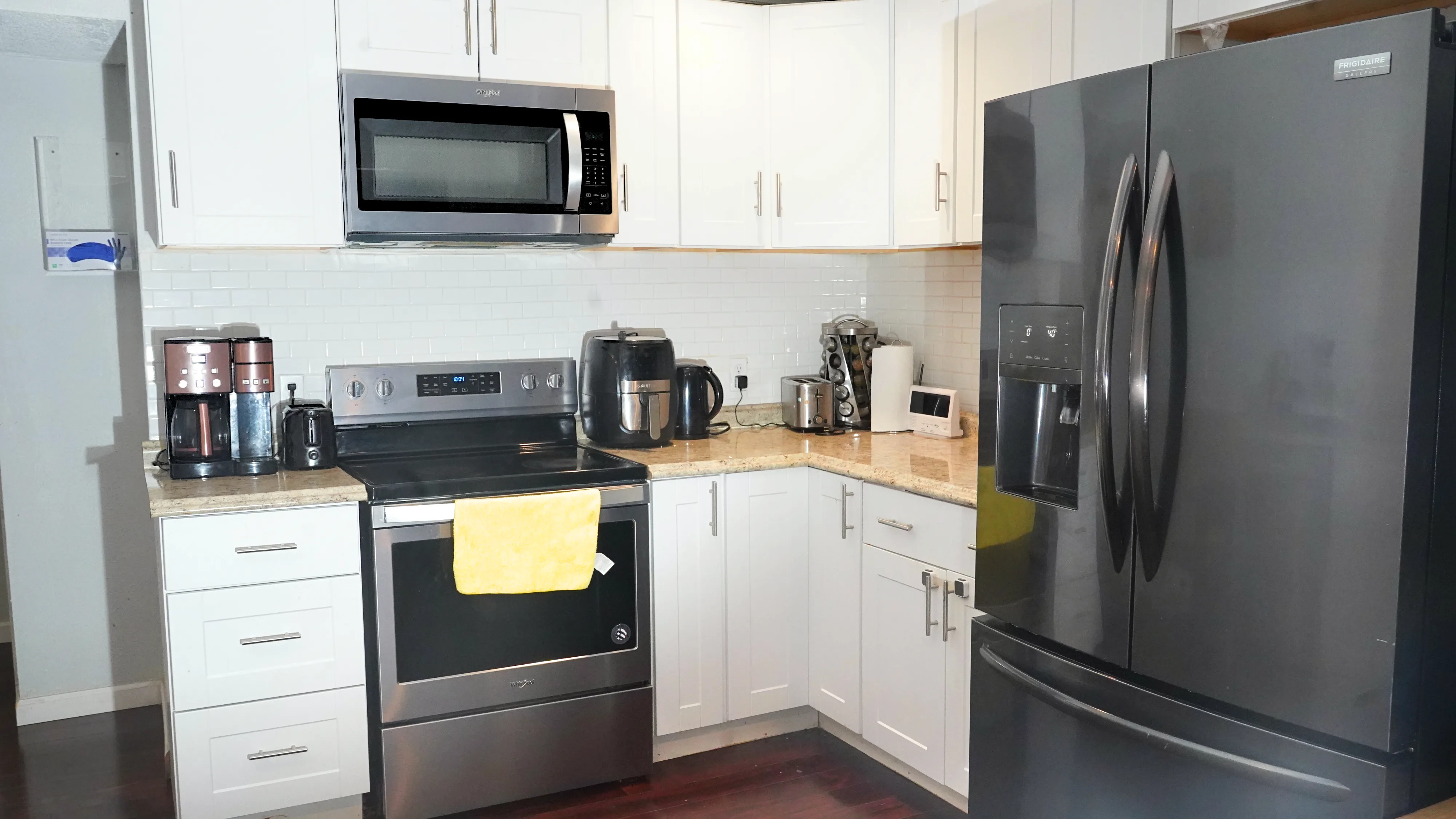Kitchen with stainless steel appliances and white cabinetry
