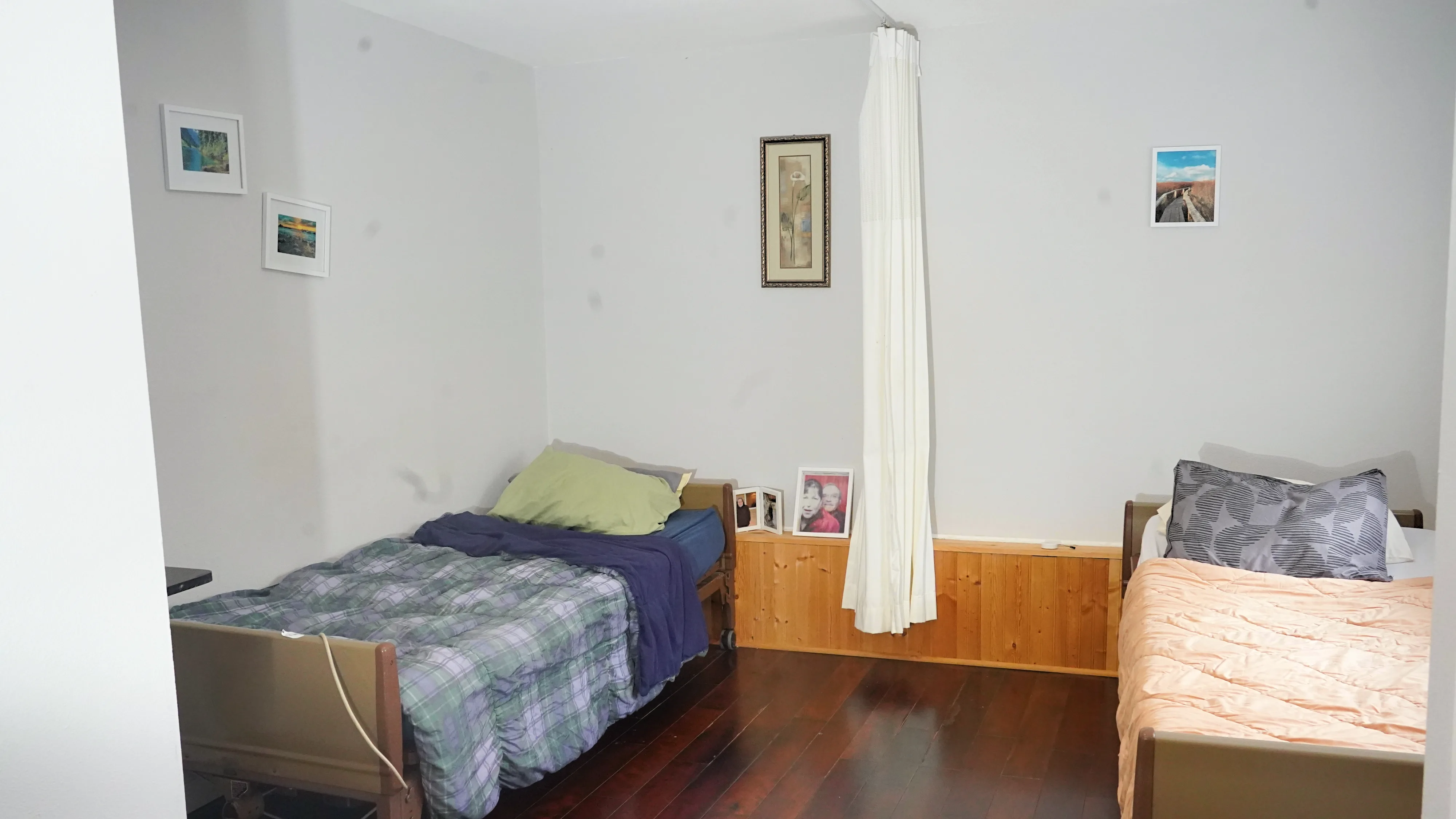 Shared bedroom with two beds and privacy curtain divider