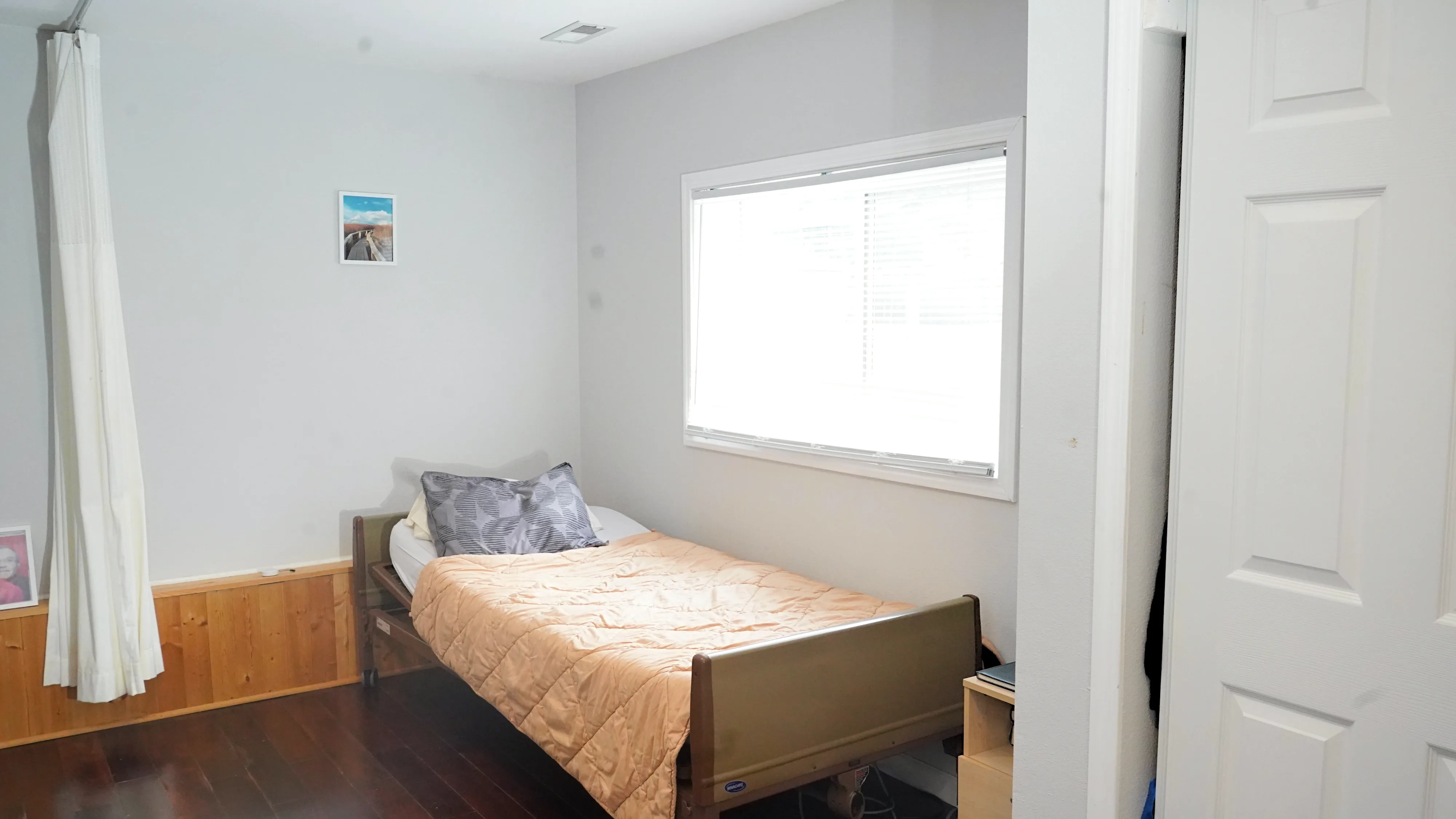Resident bedroom with adjustable bed and natural window light